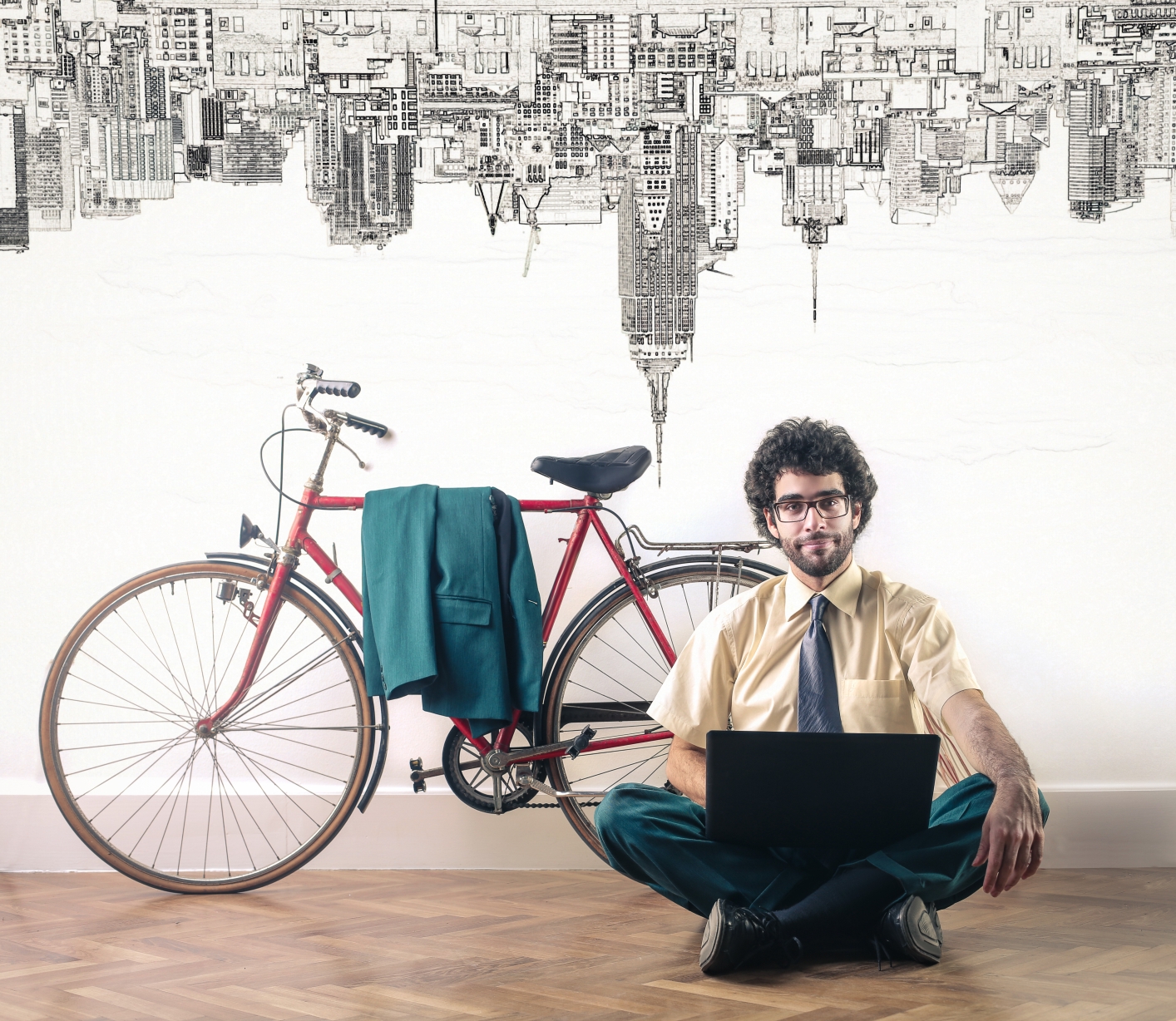 Photo: man sitting before his bike with laptop on his lap - Ollyy
